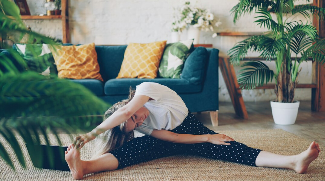 Woman stretching during a morning wellness workout at home